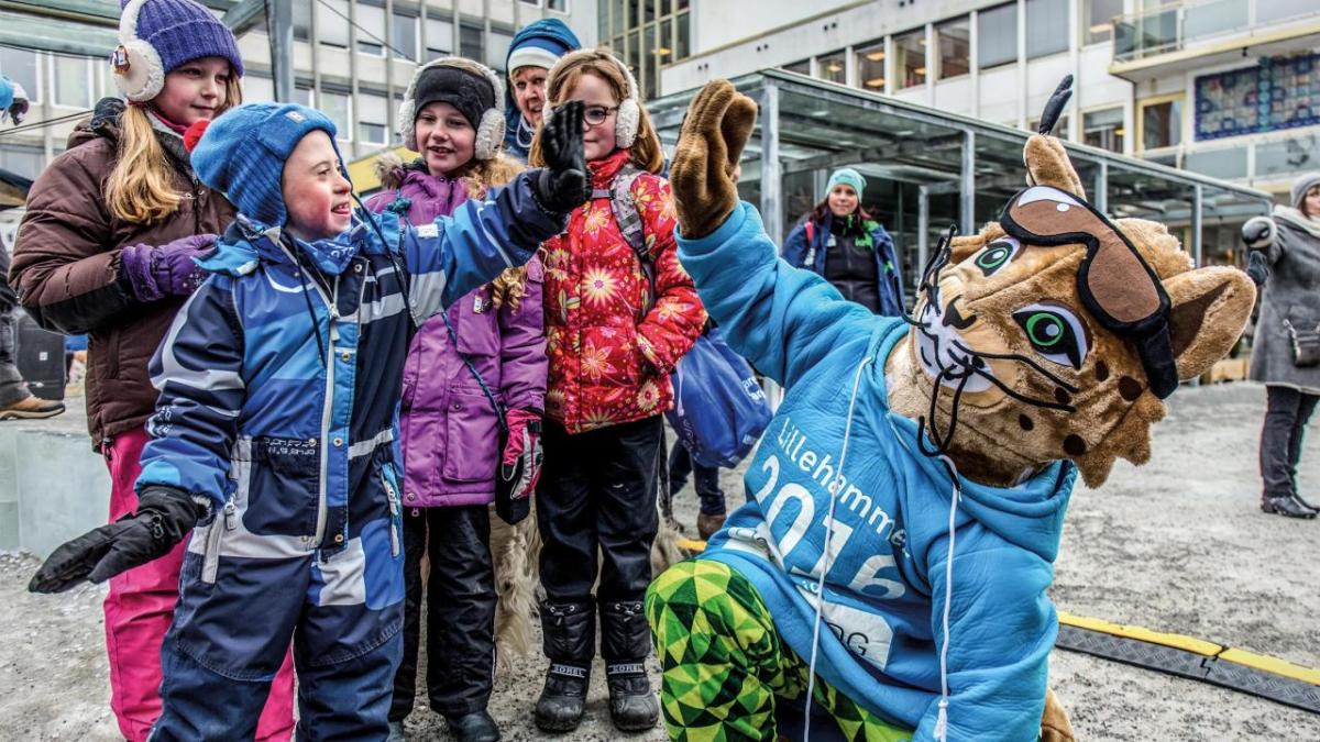 A mascott high-fiving a young child 