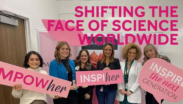 group photo of women holding signs. Reads: "Shifting the face of science worldwide"