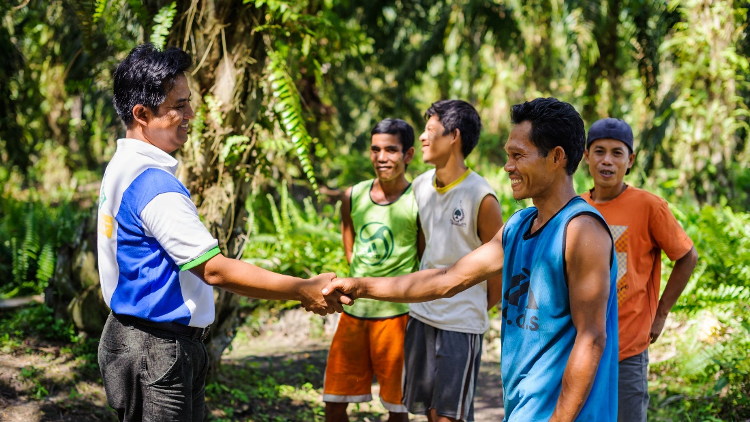 men shaking hands in forest