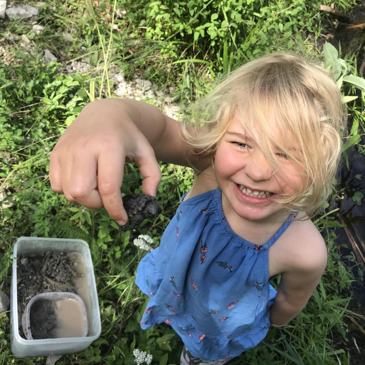 a little girl holding a turtle 