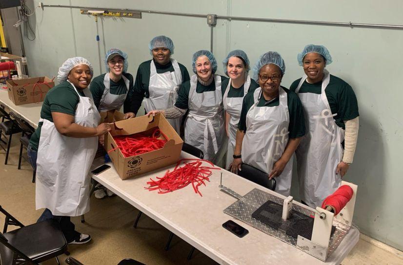 A group of people helping to package food