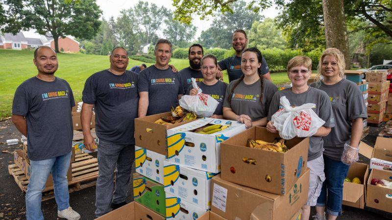Volunteers distributing boxes of food