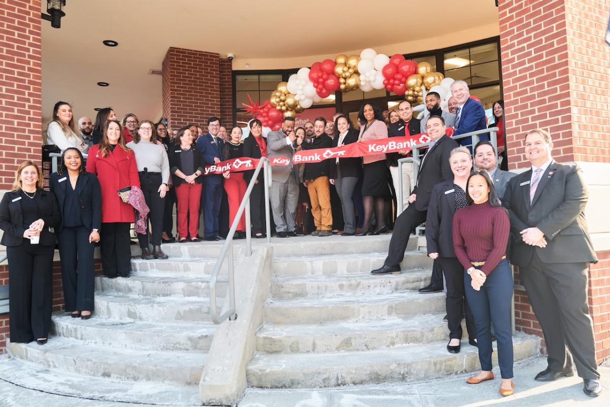 KeyBank Branch Manager Jeffrey Almanzar (center with scissors) cuts the ribbon on the bank’s newest branch at 1 Main Street Port Chester, NY at a ribbon-cutting ceremony held January 29, 2025.