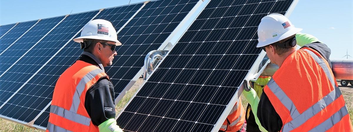 workers near a solar panel