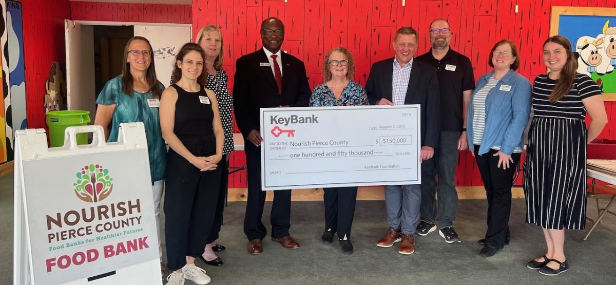 Grant check presentation between the Nourish Pierce County Food Bank and KeyBank.