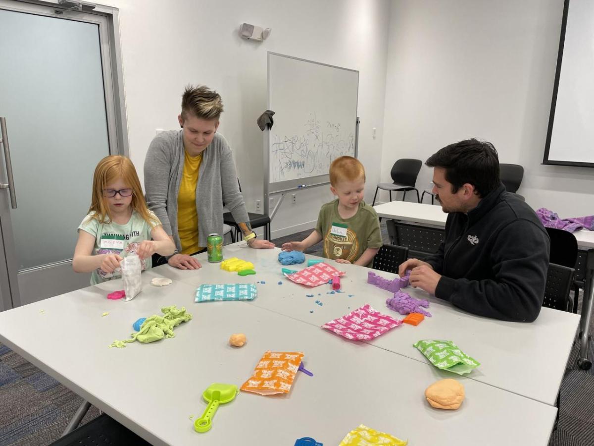 adults and children participating in science experiments and activities