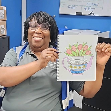 A woman coloring at Tapestry's Ohio fulfillment center