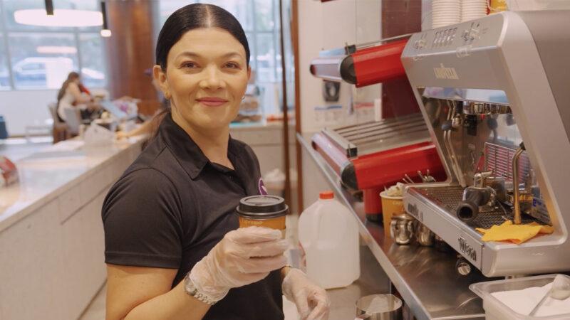 Female small businessowner making a coffee in her shop