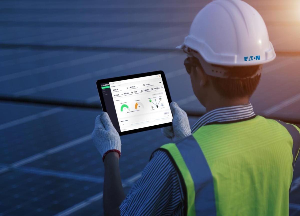 Eaton is collaborating with Xendee to optimize microgrid performance and drive greater energy resilience, efficiency and cost savings. (Image credit: Eaton) person looking at a computer tablet
