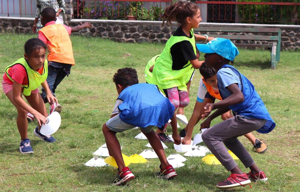 Young children playing sport outdoors