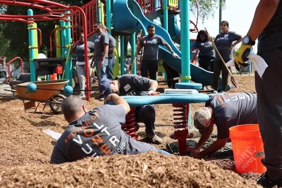 Volunteers shown assembling the playground.