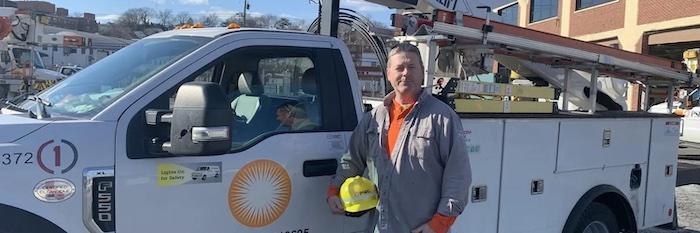 Photo of Don Brett standing in front of his PSEG truck.