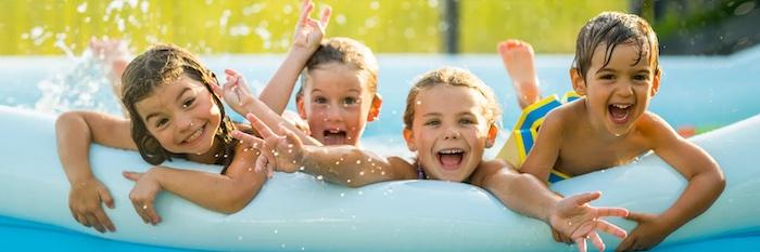 Four children in a kiddie pool.