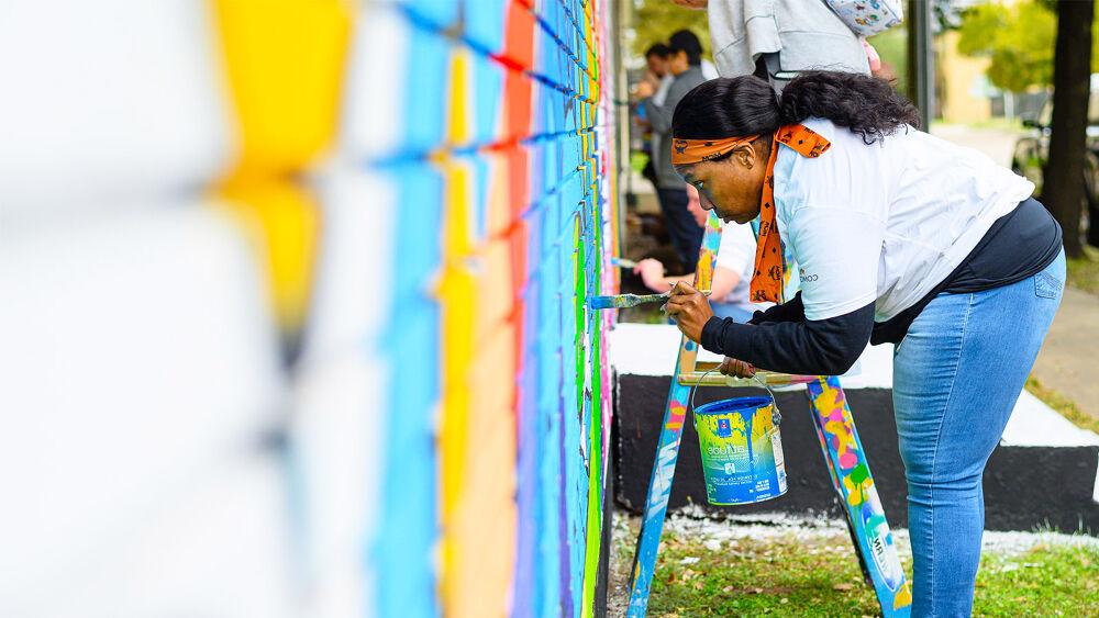 person painting a mural