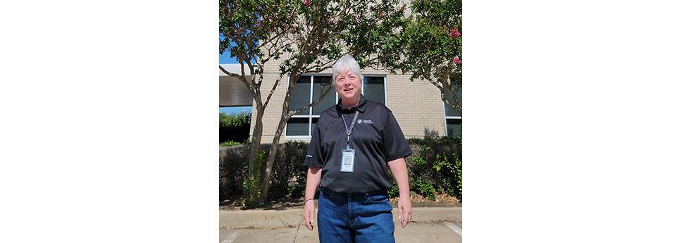 Pat Beall stood in front of a building 