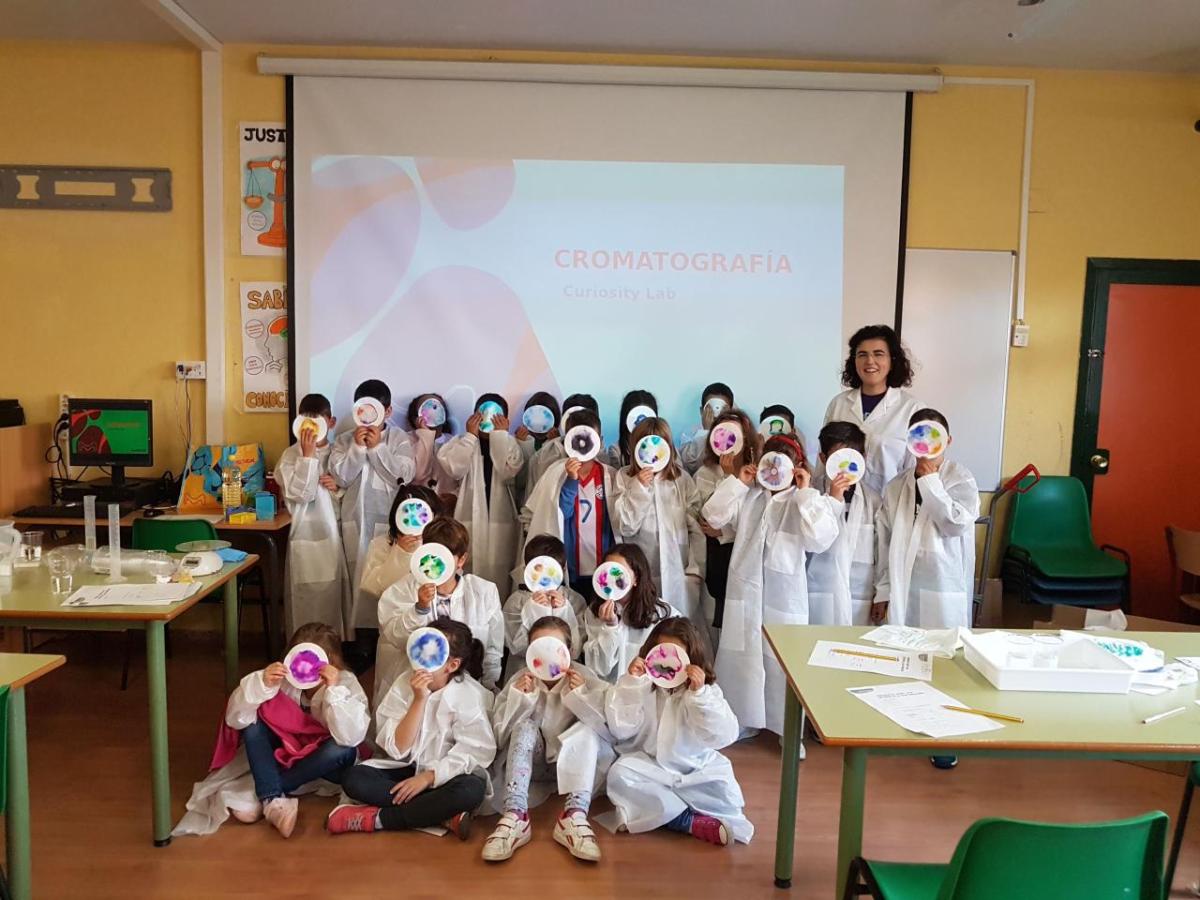 A woman stands alongside a group of children who participated in a SPARK™ lesson.