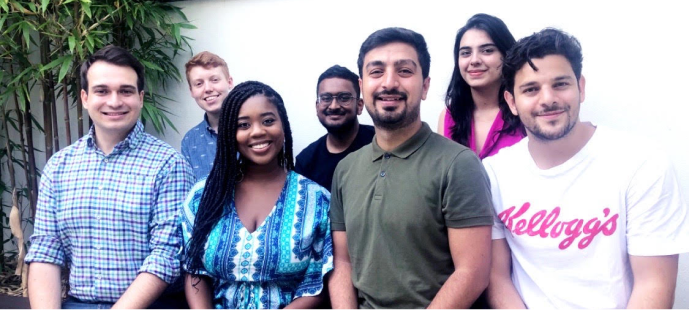 7 people pose for a photo