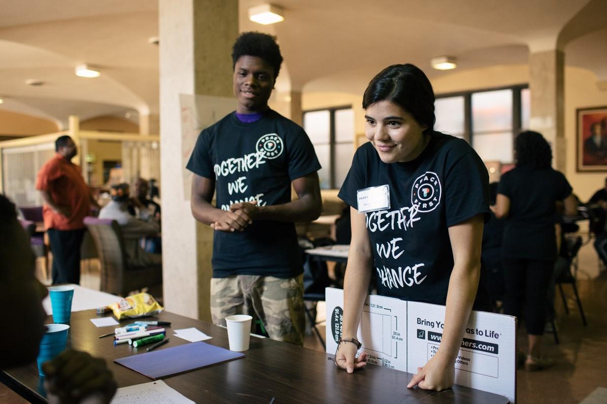 2 volunteers behind a table