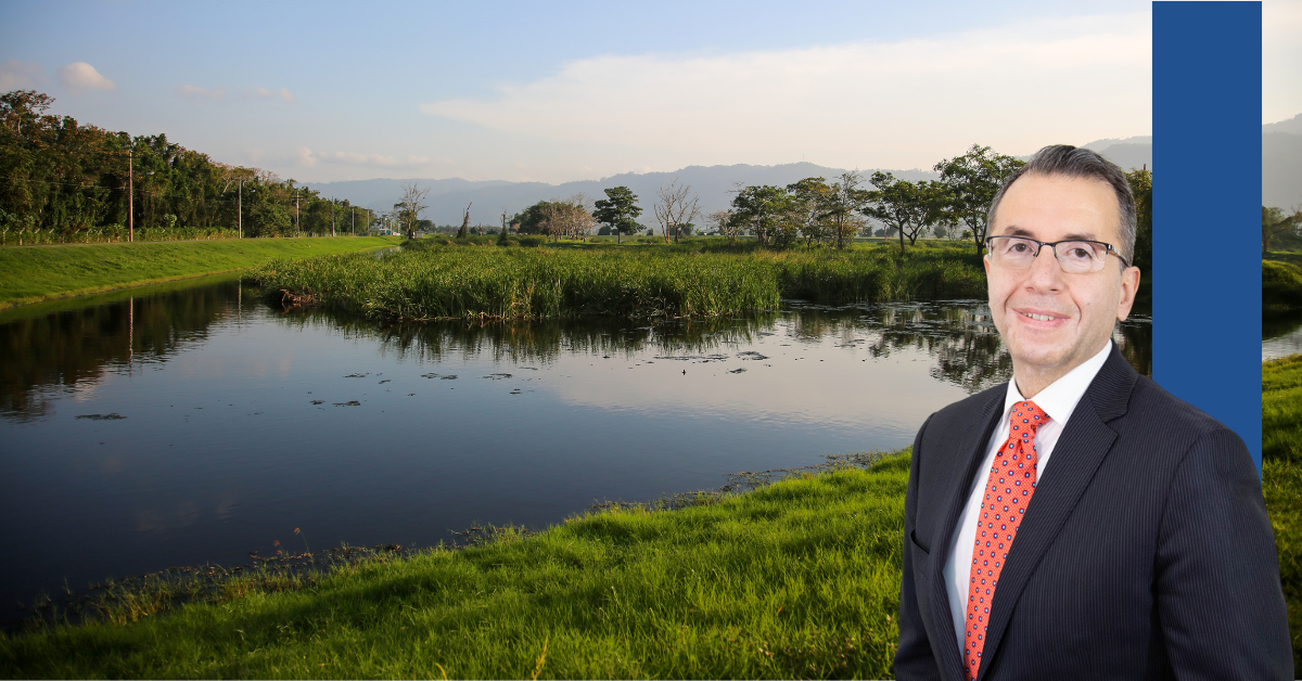 Headshot of Peter Iliopoulos against a water and trees backdrop