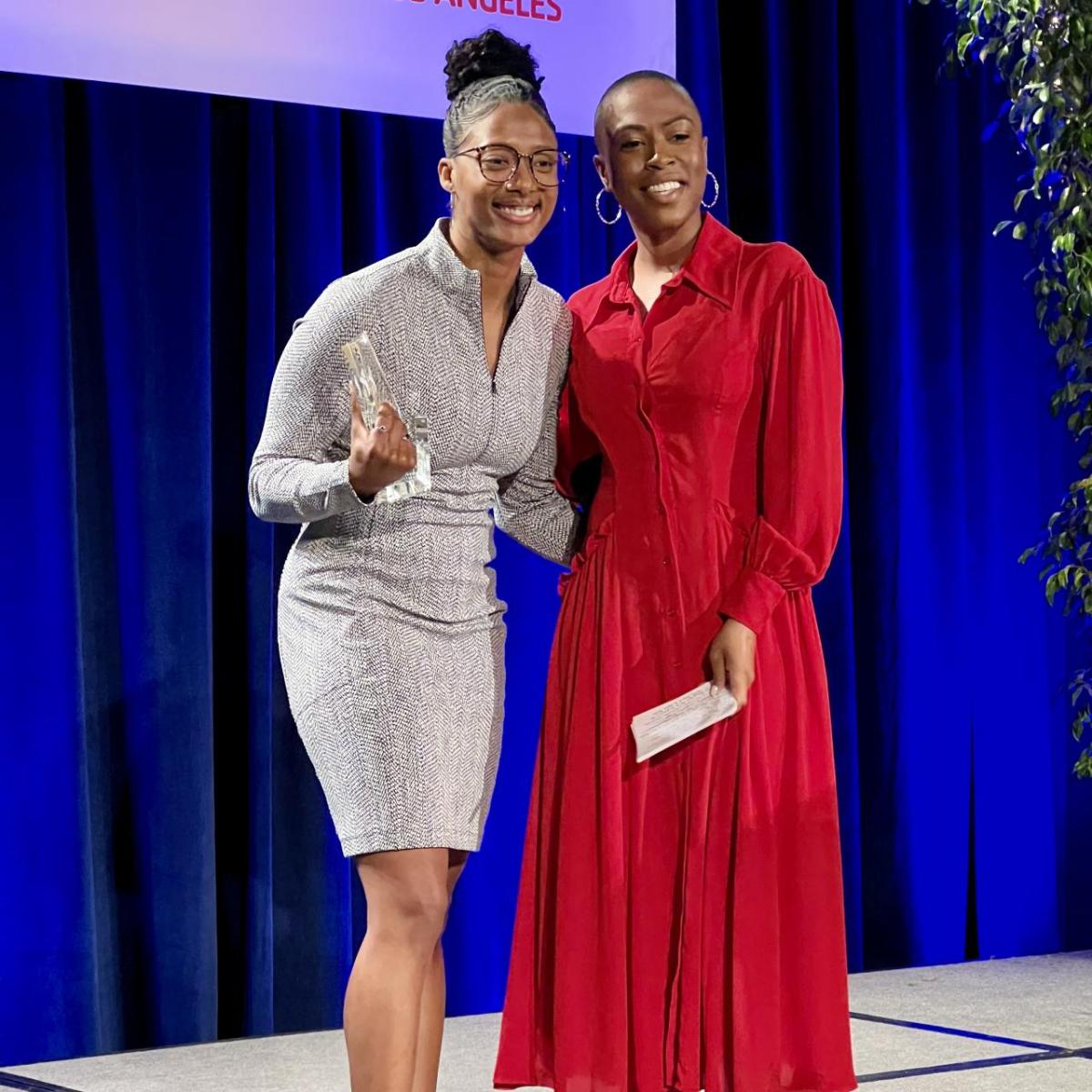 Blake Bolden is presented the YMCA's 2023 Human Dignity Award by Chelsea Crowder-Luke, Vice President at J.P. Morgan Private Bank.