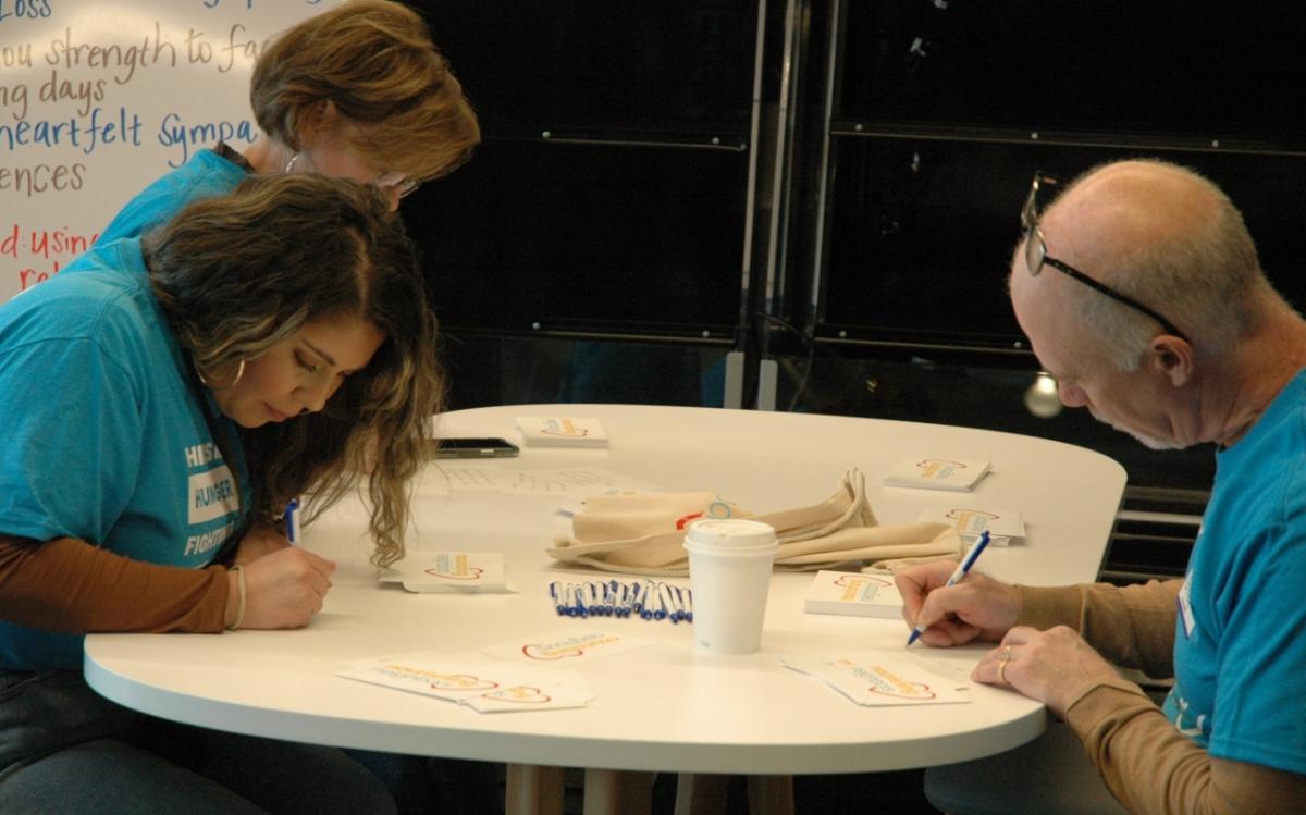 volunteers writing notes