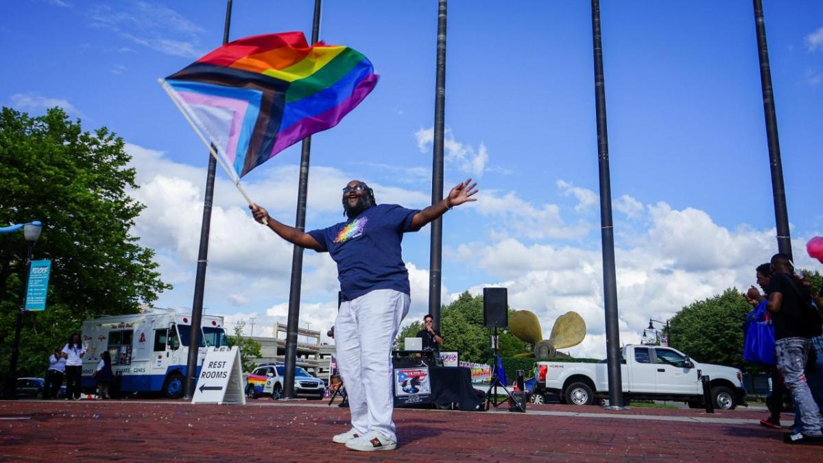 A person waving a pride flag