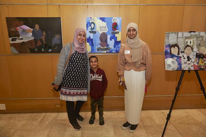 Family shown in art gallery.