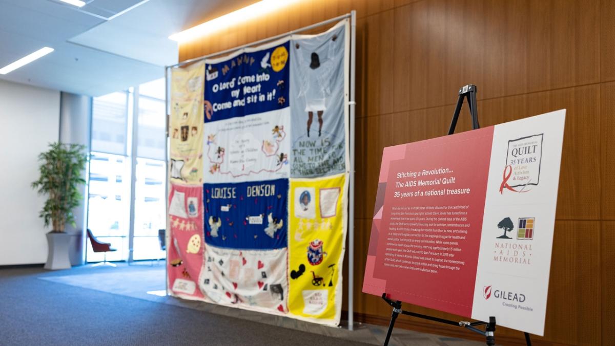 large hanging quilt and poster board to the right explaining it's significance