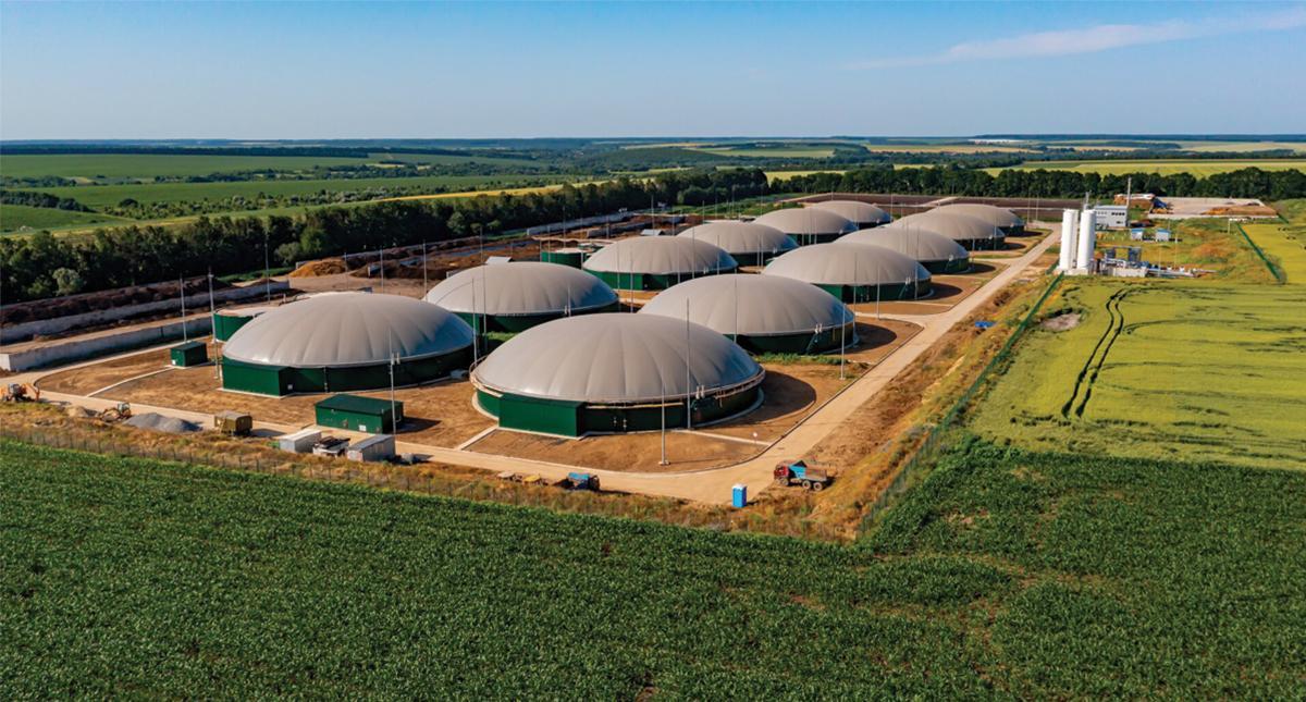 Aerial view of roes of domed buildings surrounded by farm fields.