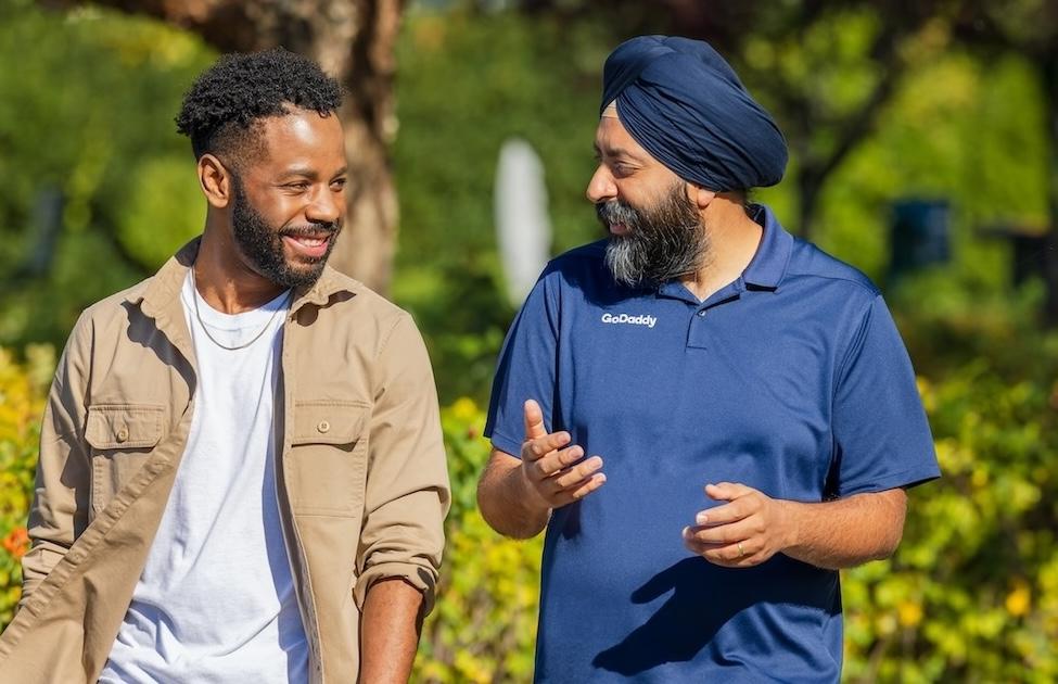 GoDaddy CEO Aman Bhutani with a GoDaddy team member.