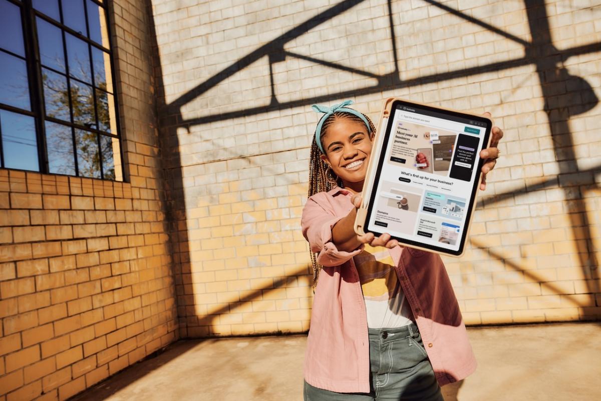 Young person holding a tablet. 