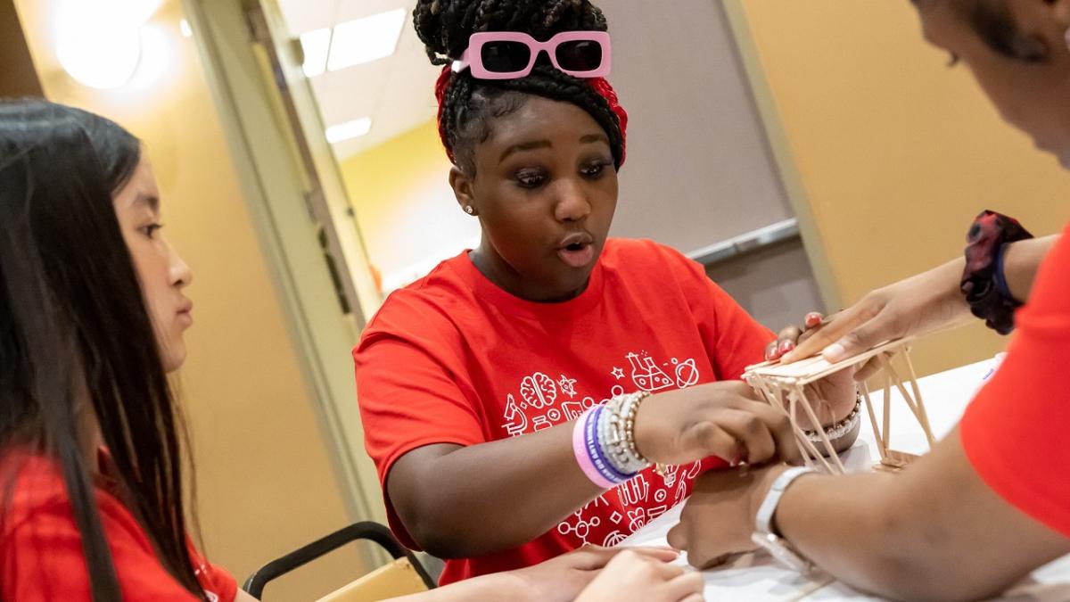 three students working on a STEM activity