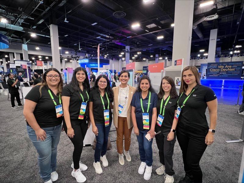 A group posed in an open exhibit hall.