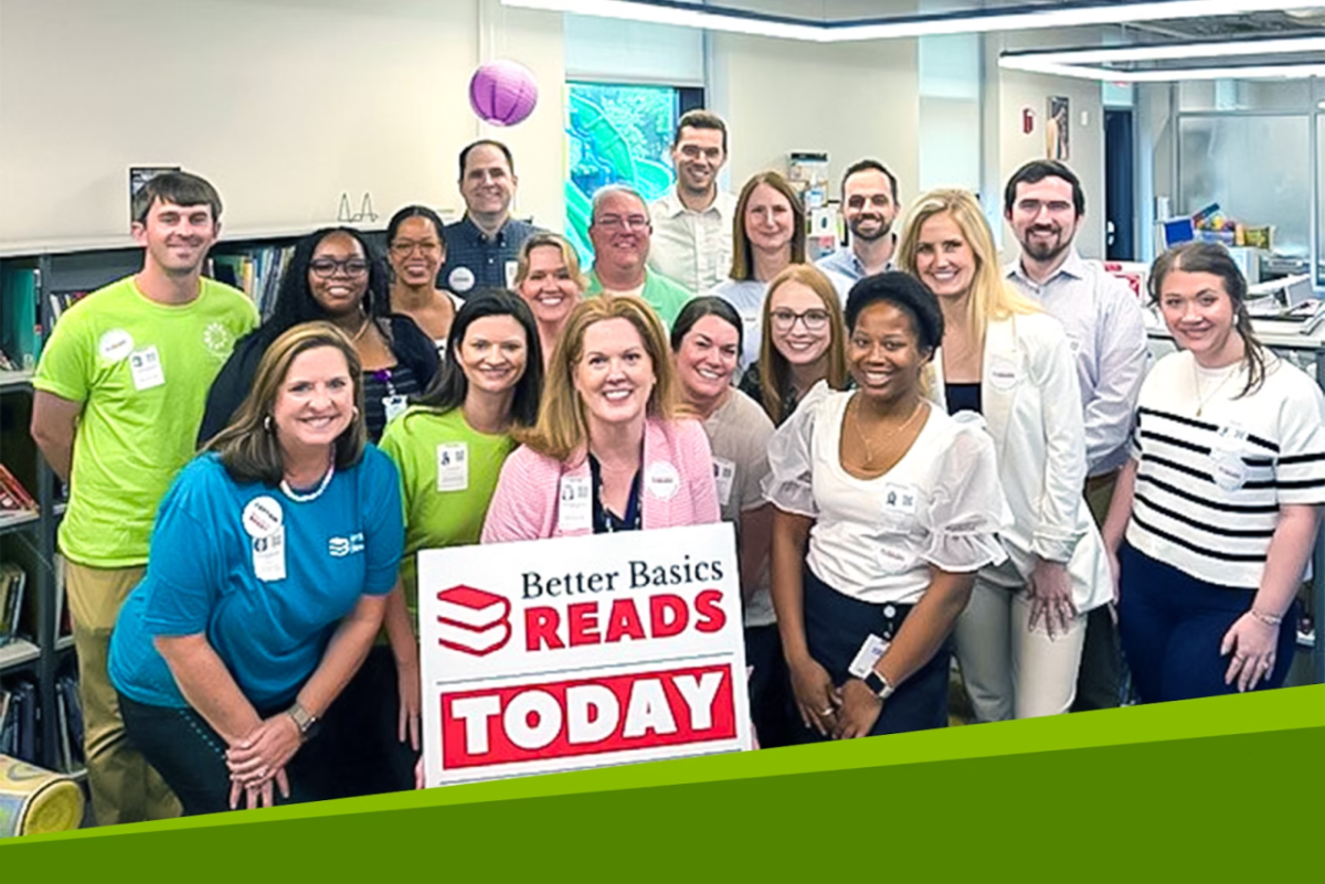 Group photo in front of sign that reads "Better Basics READS TODAY"
