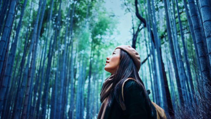 women looking around in woods