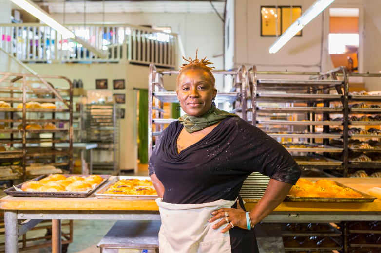 a baker standing in a bakery