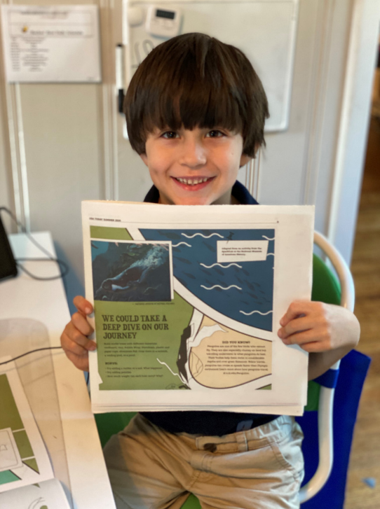 Boy holding up a learning guide