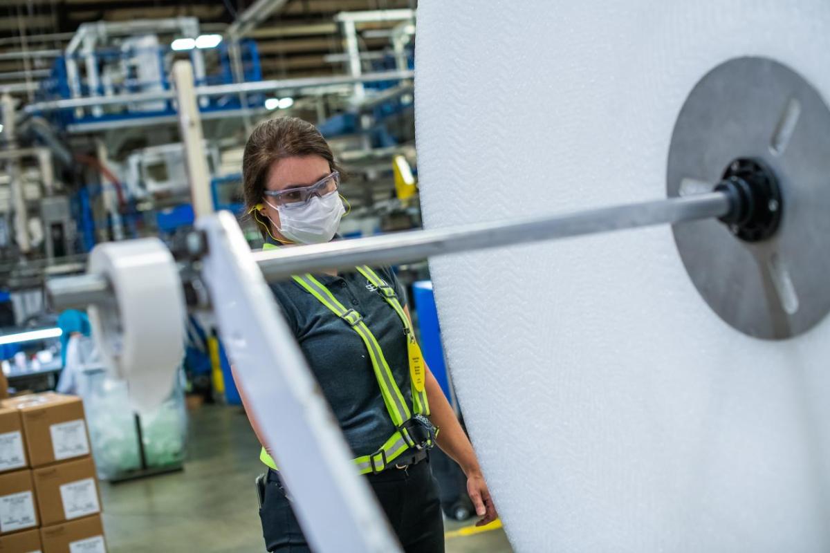 SEE manufacturing plant manager Karen Crisp inspects equipment in one of two facilities she oversees in North Carolina. Manufacturing plant manager Karen Crisp on the shop floor looking at equipment