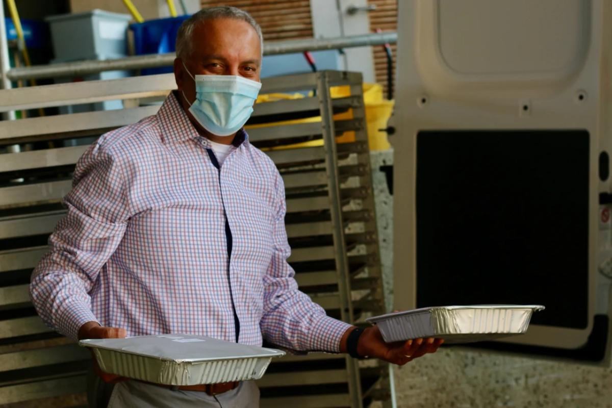 person holding packaged meals