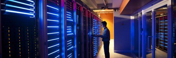 Person standing at a server rack