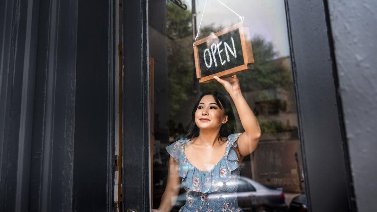 Small business owner shown opening her business.
