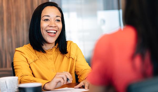 Female business owner shown speaking with an associate.