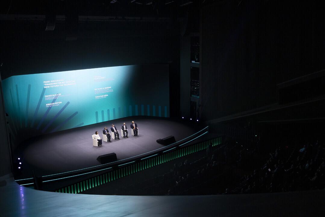 Five people sat on chairs on a stage 