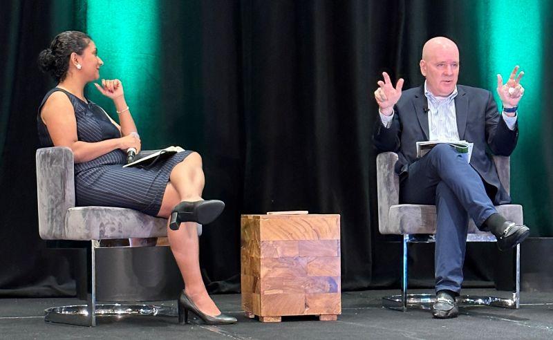 Steven Fradkin and another person seated in chairs on a stage.