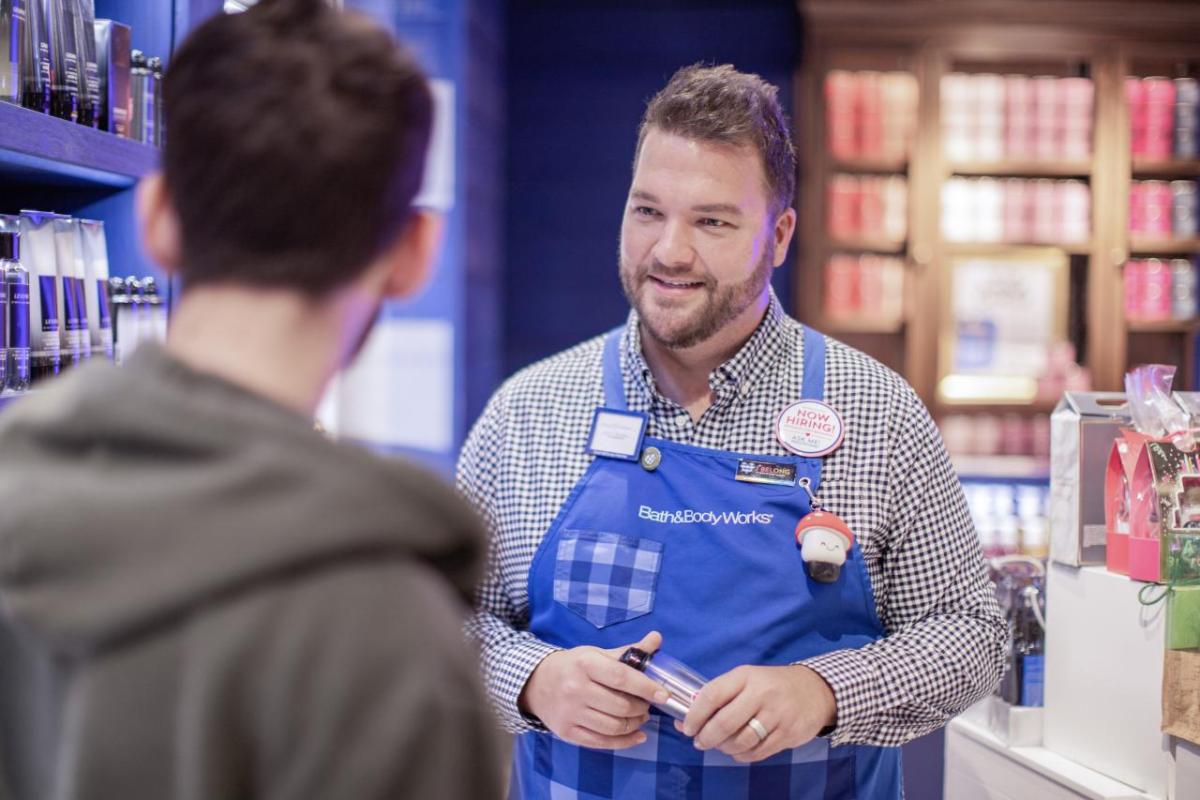 Sore associate at Bath & Body Works speaking to a customer