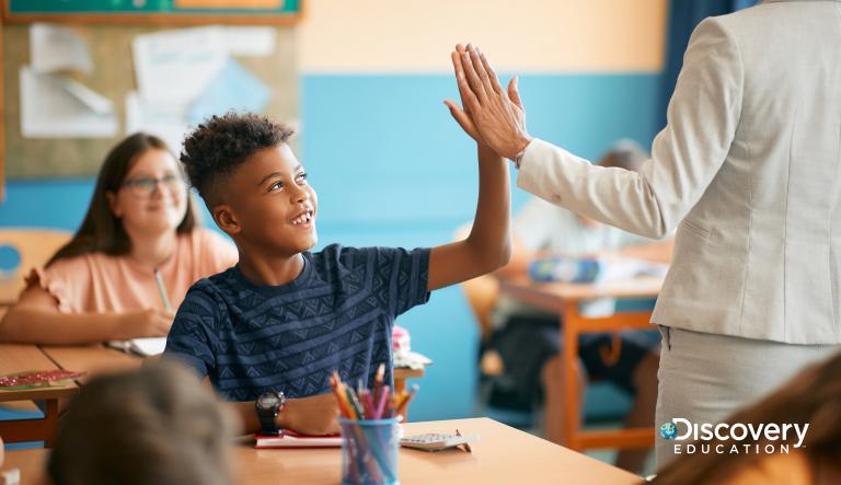 teacher high-fiving student