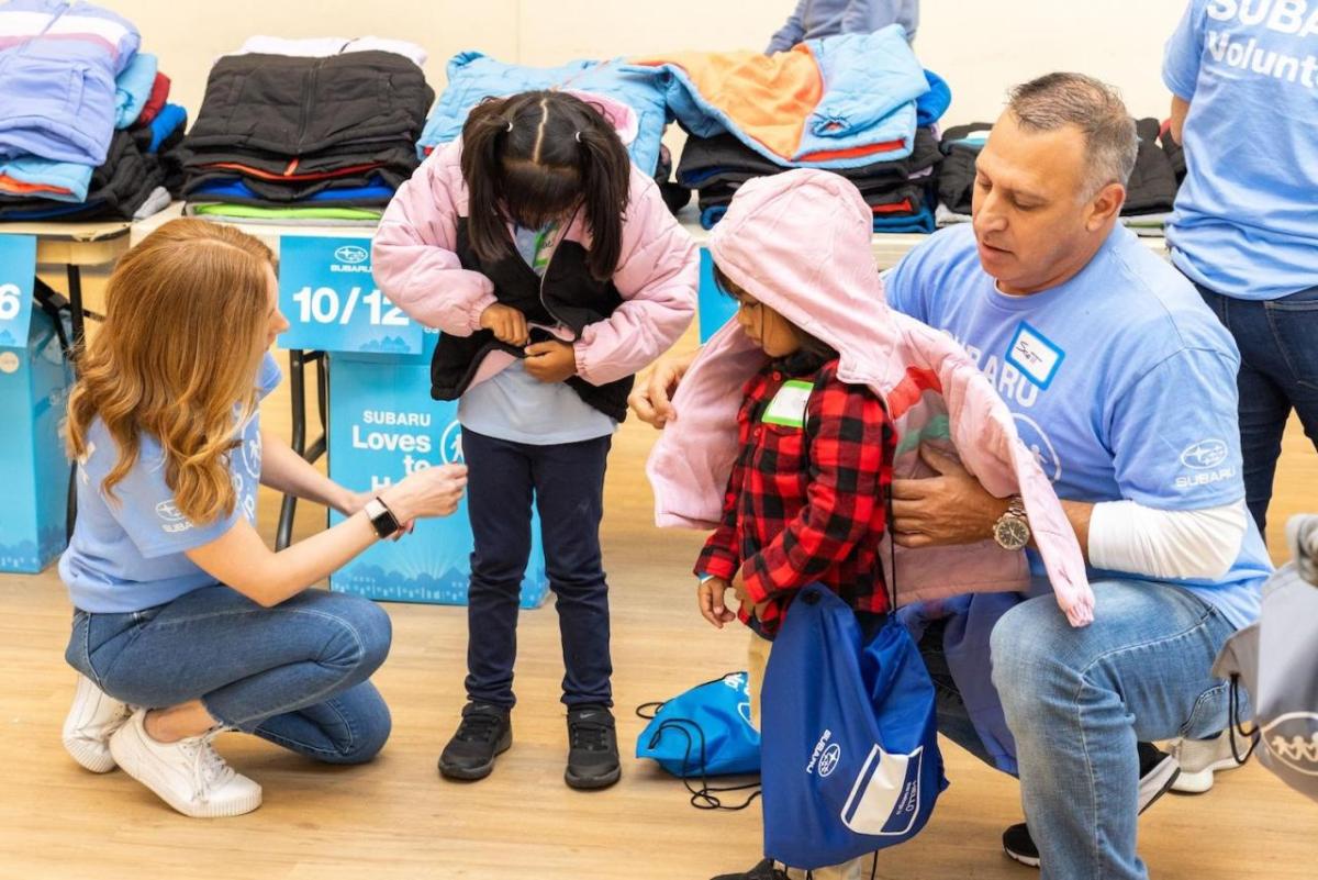 Children trying on jackets