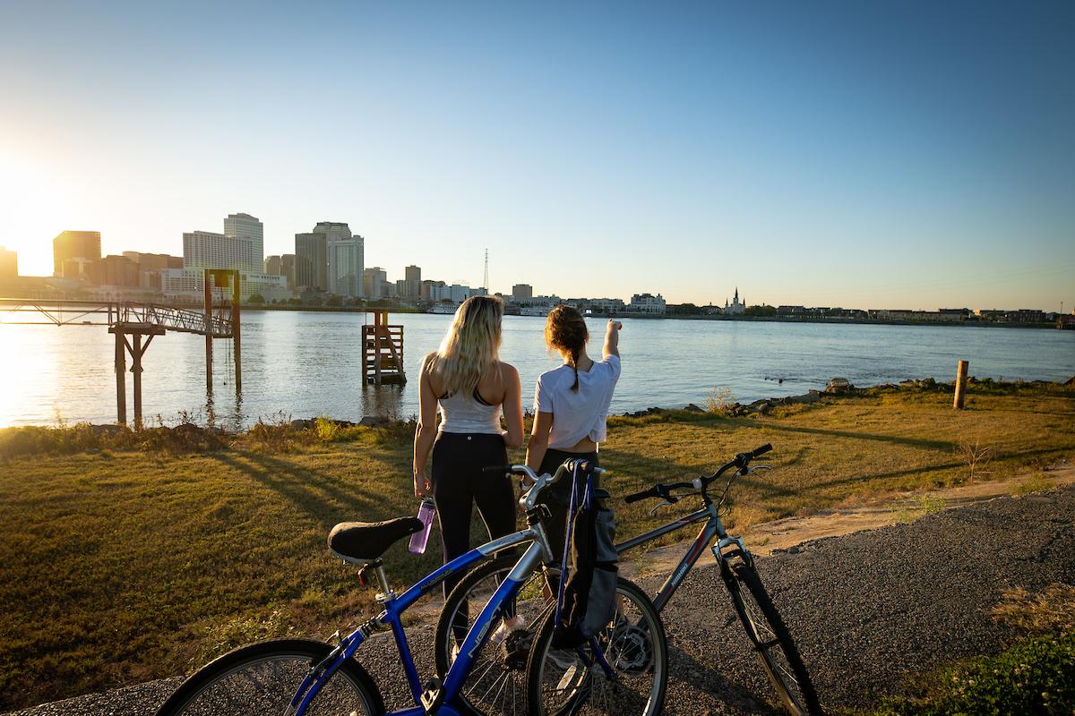 Two people looking at cityscape with bikes next to them