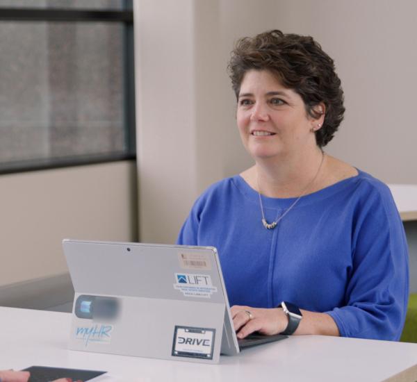 Lynn Penny sitting in front of her laptop