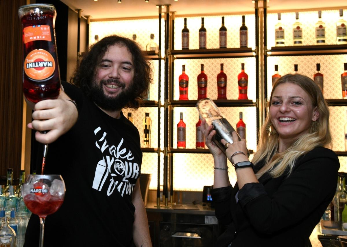 Man and woman making cocktails